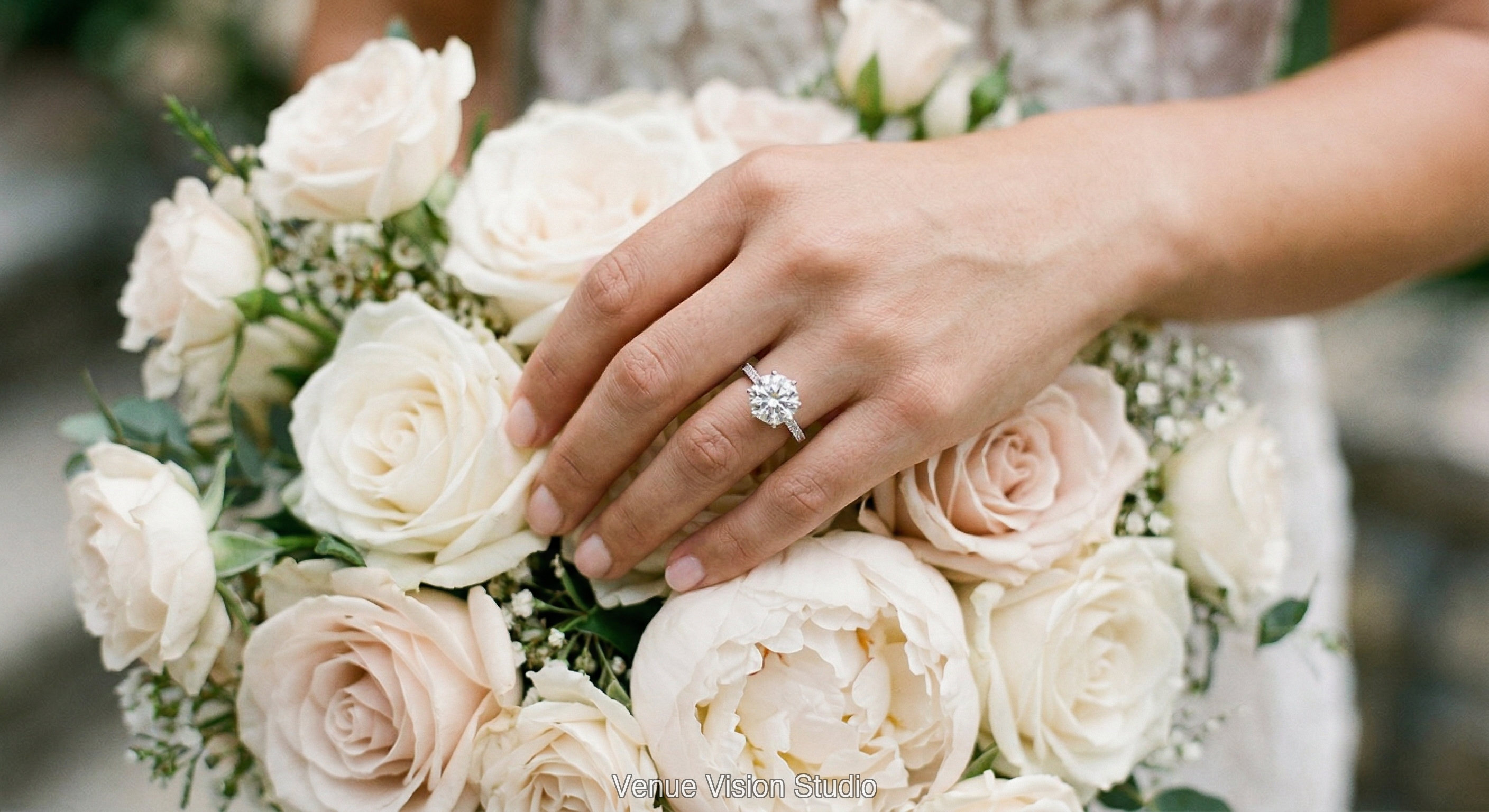 Hand with engagement ring resting on bridal bouquet