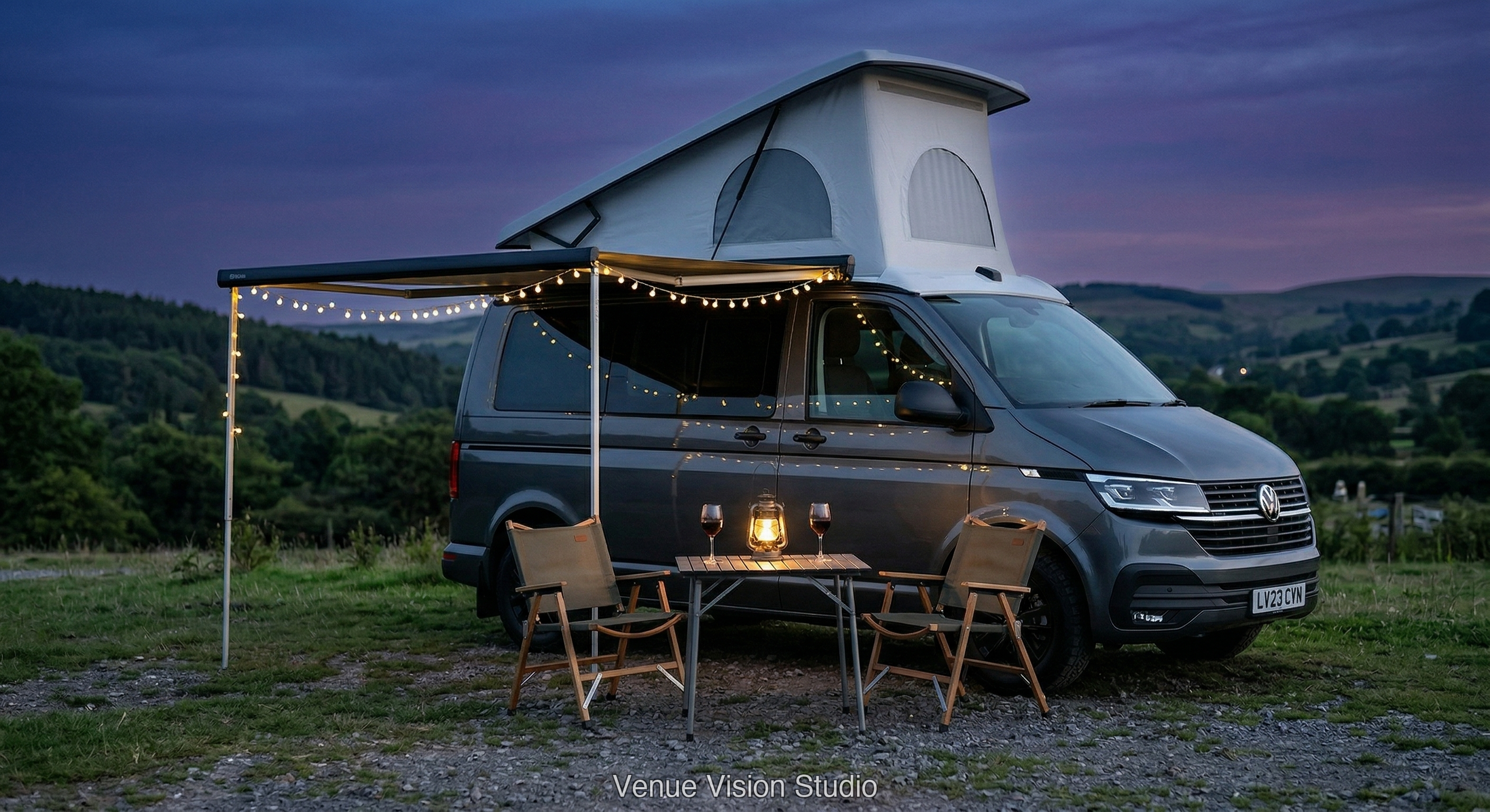 Campervan with awning and fairy lights at dusk