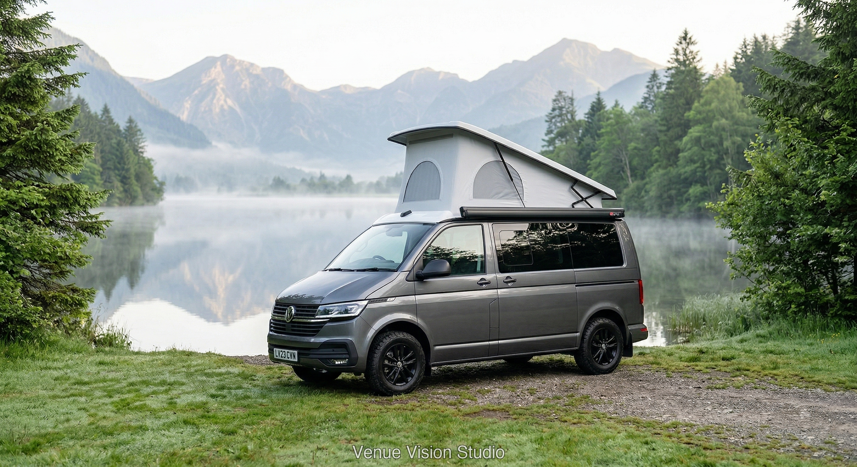Campervan beside a misty lake at dawn