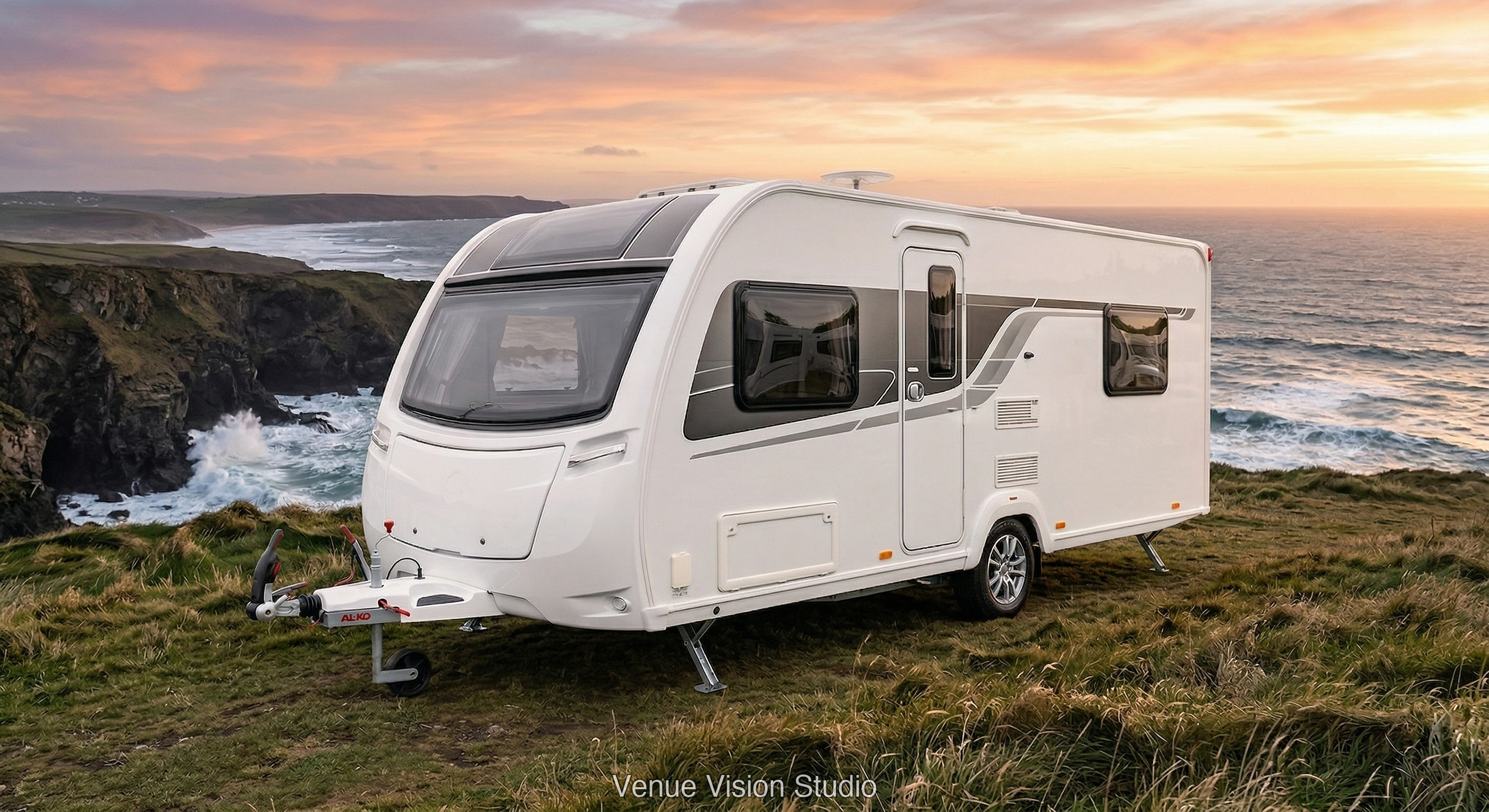 Caravan on coastal cliff at sunset
