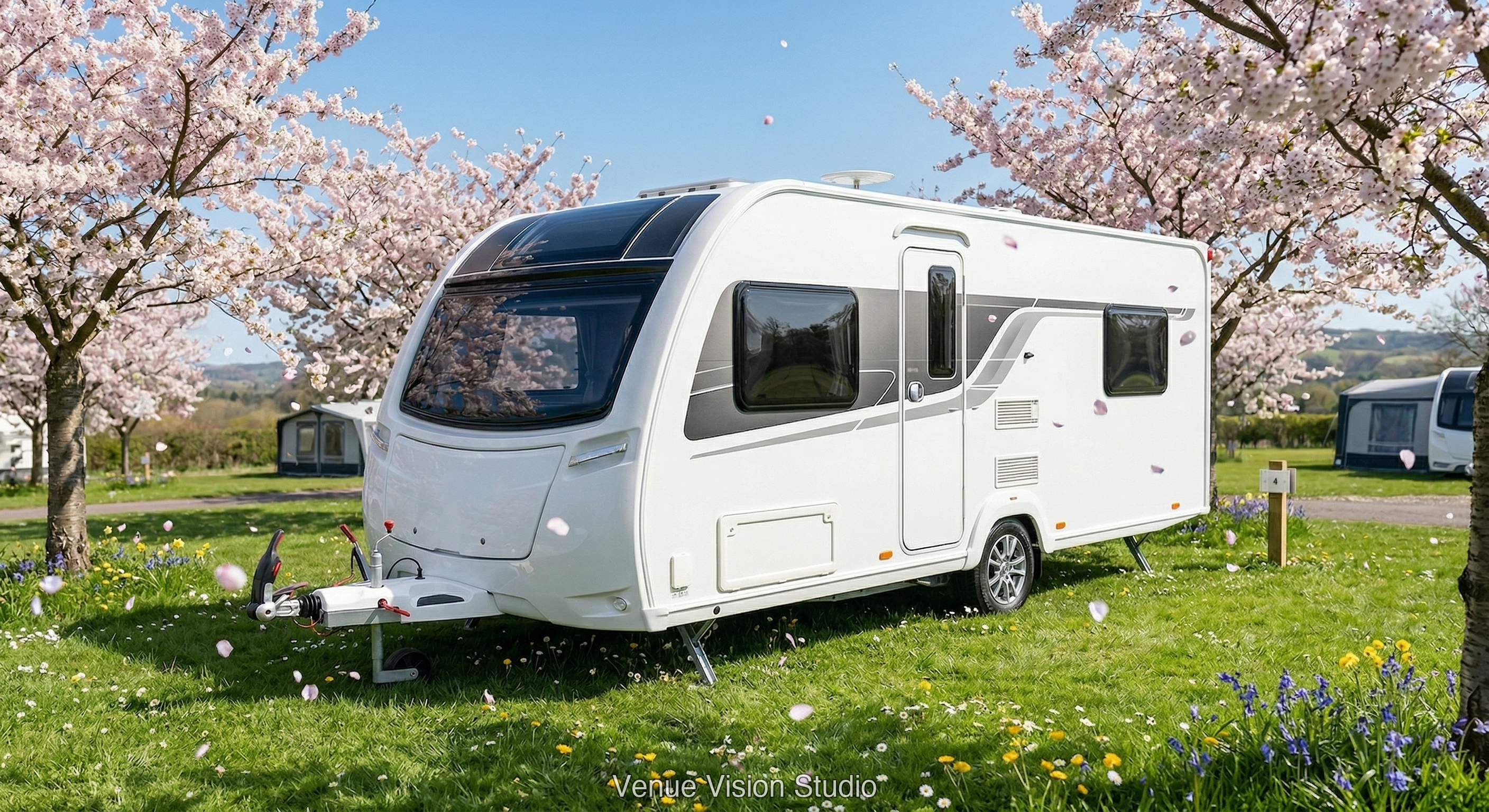 Caravan at spring campsite with cherry blossom